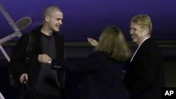 Matthew Miller es saludado por sus familiares a la llegada a la Base Lewis-McChord, en el estado de Washington.