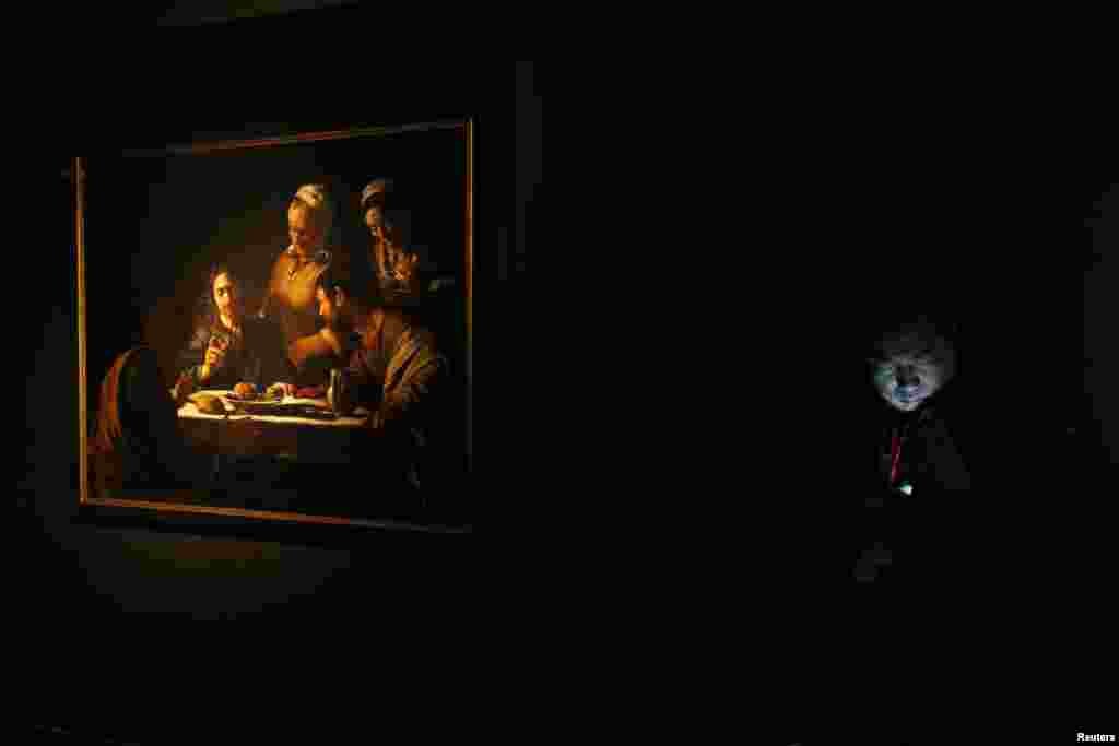 Seorang petugas keamanan menjaga lukisan Baroque karya pelukis Italia, Caravaggio, yang dipamerkan di sebuah gallery seni di Hong Kong.