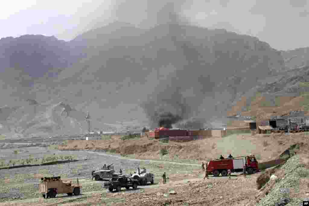 Afghan border police and firefighters arrive at the scene of an attack by militants on a U.S. base in Torkham, Afghanistan, Sept. 2, 2013.