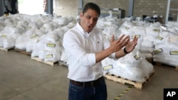 Venezuelan exiled lawmaker Jose Manuel Olivares talks to the media during a tour to see stored humanitarian aid at a warehouse next to the Tienditas International Bridge on the outskirts of Cucuta, Colombia, on the border with Venezuela, Feb. 19, 2019. 