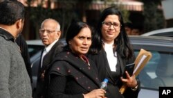 Asha Devi, center, mother of the victim of the fatal 2012 gang rape on a moving bus, leaves the Supreme Court in New Delhi, India, Dec. 18, 2019. 