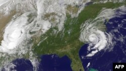 FILE - This May 10, 2015 NOAA satellite photo shows Tropical Storm Ana (R) off the Carolinas. Ana made landfall on the US southeastern coast risking flooding, high winds and life-threatening tides in the region.