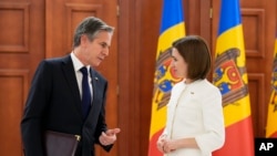 U.S. Secretary of State Antony Blinken, left, speaks to Moldova's President Maia Sandu at a joint news conference following their talks in Chisinau, Moldova, March 6, 2022.