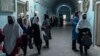 FILE - Afghan girls exit classrooms at Tajrobawai Girls High School, in Herat, Afghanistan, Nov. 25, 2021.