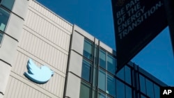 FILE - A Twitter logo hangs outside the company's San Francisco offices on Nov. 1, 2022. 