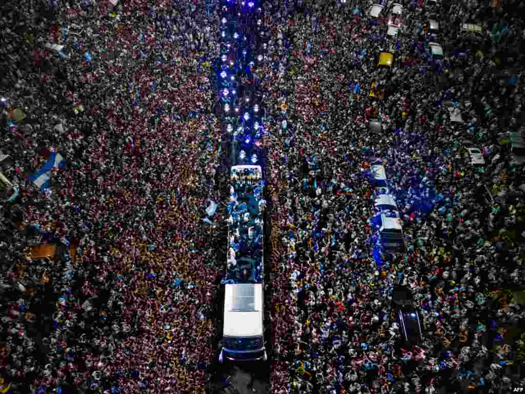 Argentina's soccer team is welcomed by fans after winning the Qatar 2022 World Cup tournament as they leave from Ezeiza International Airport to the Argentine Football Association training center in Ezeiza, Buenos Aires province.