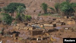 FILE - The Bento Rodrigues district is pictured covered with mud after a dam owned by Vale SA and BHP Billiton Ltd burst in Mariana, Brazil, Nov. 6, 2015.