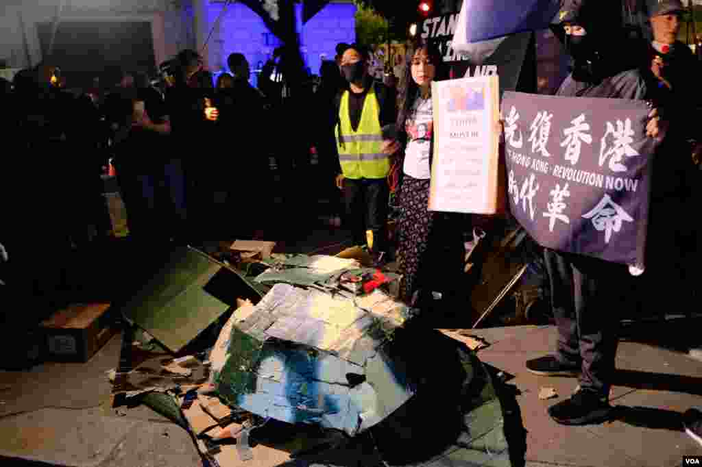 示威者在結束抗議前在中國大使館外打爛紙紮坦克。(美國之音鄭樂捷)