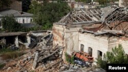 Destroyed houses and cars are seen in the town of Izium, recently liberated by Ukrainian Armed Forces, in Kharkiv region, Ukraine, Sept. 20, 2022.