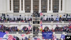 FILE - Insurrectionists loyal to President Donald Trump breach the Capitol in Washington, Jan. 6, 2021.