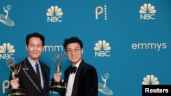12일 미국 로스앤젤레스에서 열린 제 74회 에미상에서 감독상을 받은 '오징어 게임'의 황동혁(오른쪽) 감독과 남우주연상 이정재 씨가 트로피를 들어 올리고 있다.