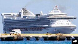 An ambulance waits at a dock upon the arrival of the cruise ship Grand Princess as it arrives in the port of Mahaual, Mexico, March 26, 2007.
