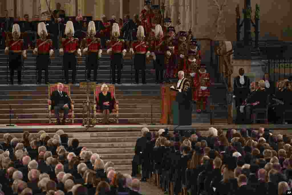 King Charles III and Camilla, the Queen Consort, listen to Speaker of the House of Commons Sir Lindsay Hoyle, in Westminster Hall in London, where both Houses of Parliament met to express their condolences, following the death of Queen Elizabeth II.
