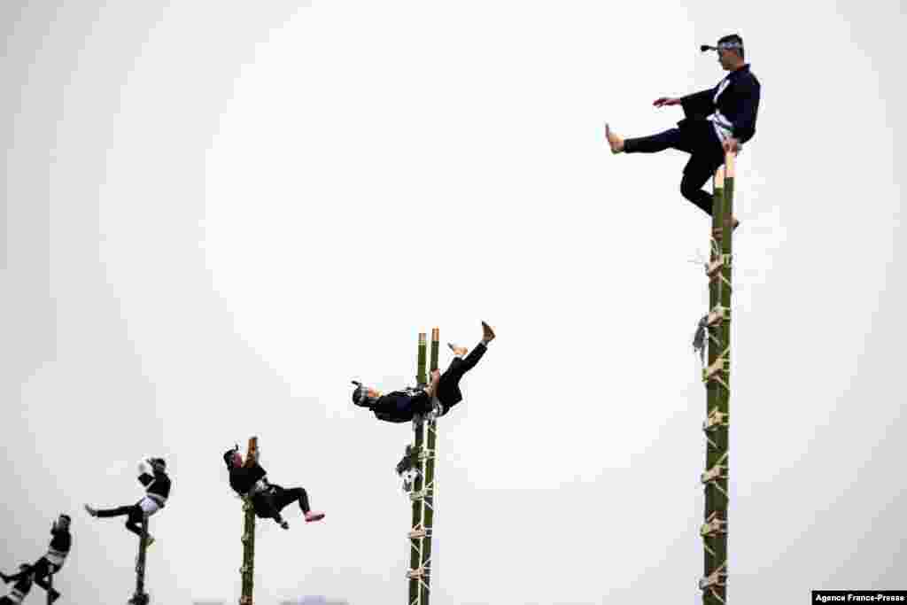 Members of the Edo Firemen Preservation Association perform Japanese traditional firefighting techniques during the New Year's fire brigades exercise in Tokyo.