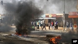 Protesters burn tires and close the highway to northern cities amid a wave of unrest over the lifting of fuel subsidies by the Sudanese government, in Kadro, Sudan, Sept. 25, 2013.