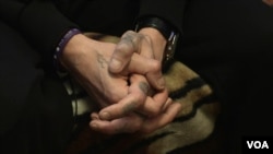 A Russian drug addict holds his hands together during a rehab session at the Vershina-Navigator Foundation's rehabilitation center outside Moscow. The number of Russians infected with HIV is growing and has surpassed 1 million, according to groups tracking global infection rates.