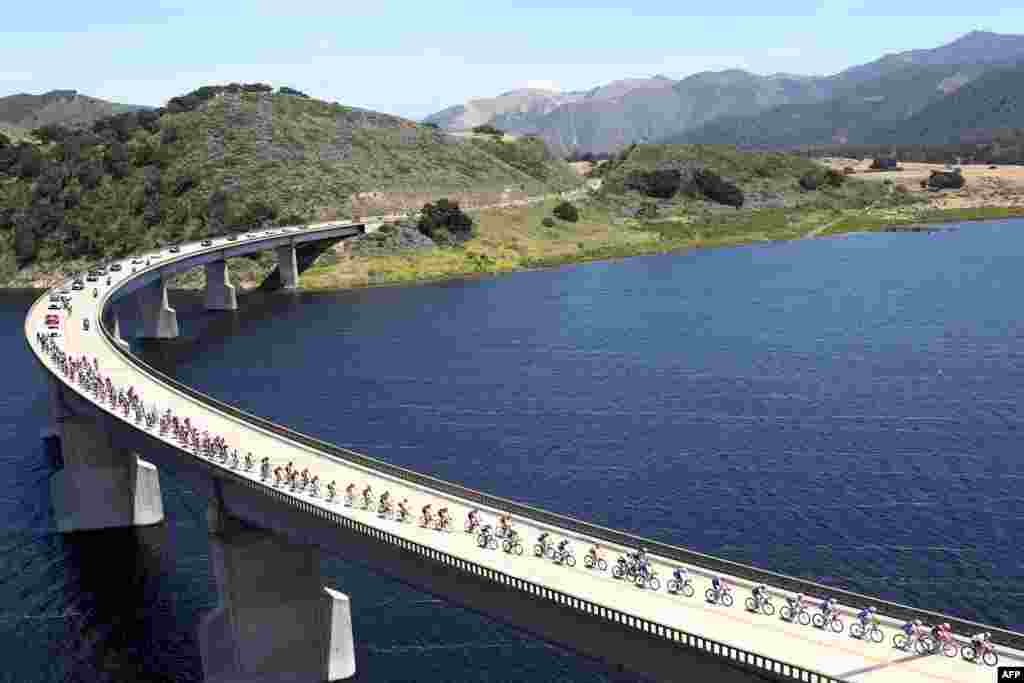 The peloton rides across Twitchell Reservoir during stage 3 of the AMGEN Tour of California from Pimo Beach to Morro Bay, in Morro Bay, California, May 16, 2017.