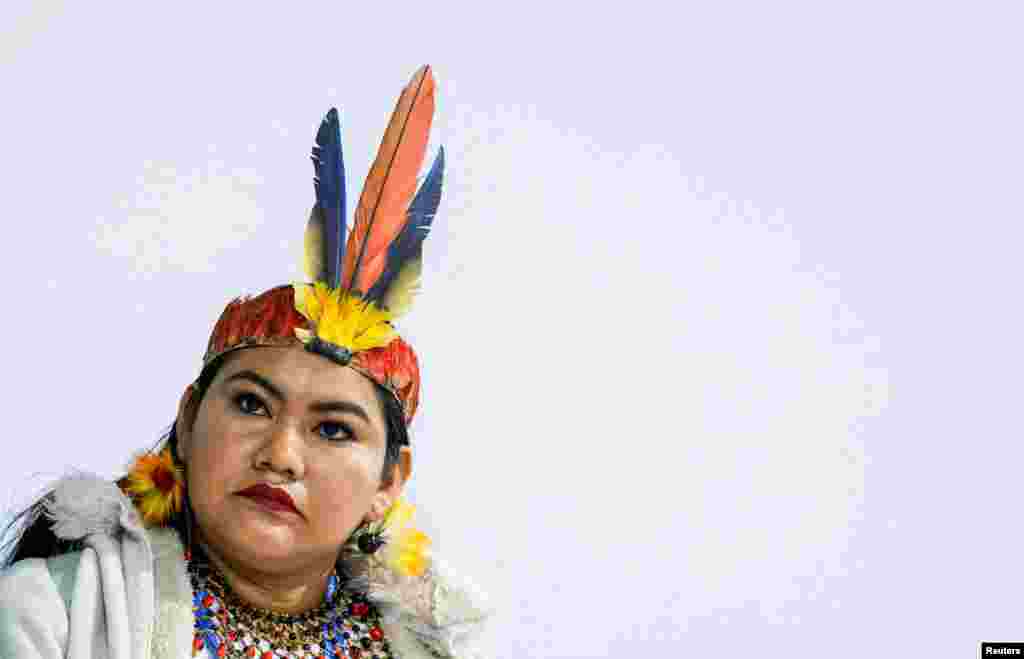 A woman looks on during the indigenous people's protest during the United Nations Climate Change Conference (COP29), in Baku, Azerbaijan.