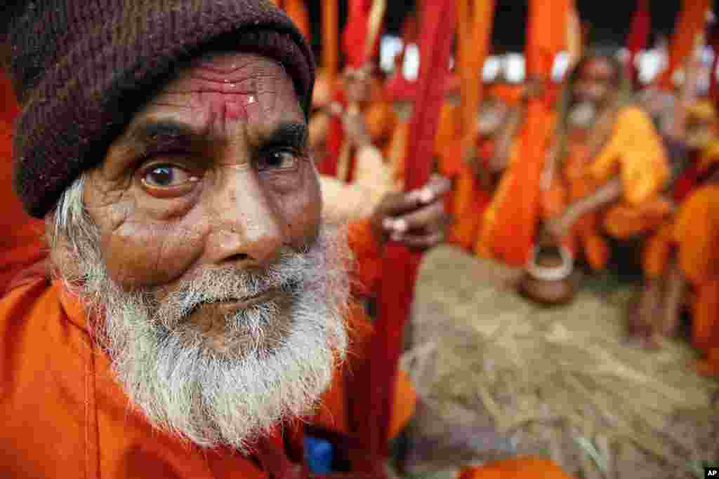 Indian Sadhus, or Hindu holy man participate in a community feast at Sangam, the confluence of the Rivers Ganges, Yamuna and mythical Saraswati river during the annual month-long Hindu religious fair of Magh Mela in Allahabad, India.