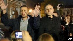 Alexei Navalny, a prominent anti-corruption whistle blower and blogger, left, and opposition leader Sergei Udaltsov, address protesters, Moscow, May 8, 2012.