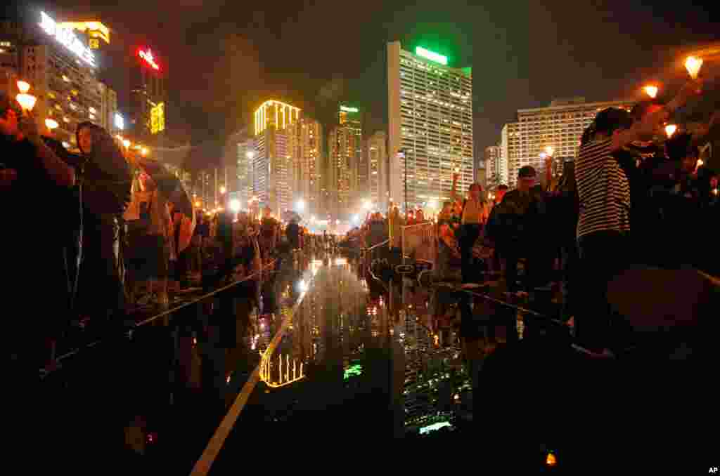 Tens of thousands of people attend a candlelight vigil at Hong Kong's Victoria Park, June 4, 2013