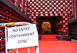 A health notice hangs on railing of a closed "pandal" or a temporary platform, on the first day of Durga Puja festival, amidst the spread of COVID-19 in Kolkata, India, Oct. 22, 2020.
