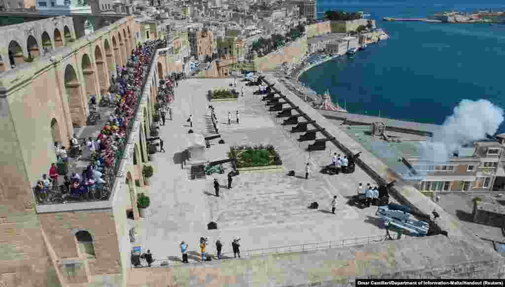 Gunners of the Armed Forces of Malta fire a 21-gun-salute in honor of Britain's Queen Elizabeth during her funeral, at the Saluting Battery overlooking Grand Harbor in Valletta, Malta, Sept.19, 2022.