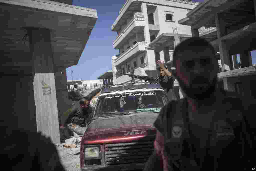 Opposition fighters prepare for battle during an attack on the Wadi al-Deef military post at the frontline in Maaret al-Numan in Idlib province, Syria, Oct. 7, 2013.