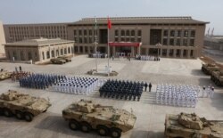 FILE - Chinese People's Liberation Army personnel attend the opening ceremony of China's new military base in Djibouti, Aug. 1, 2017.