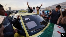 Cidadãos sírios festejam durante o terceiro dia da tomada da cidade pelos insurrectos em Damasco, Síria, terça-feira, 10 de dezembro de 2024.