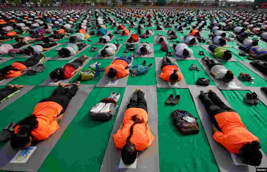 People perform yoga during a practice session ahead of the International Yoga Day, in Lucknow, India.