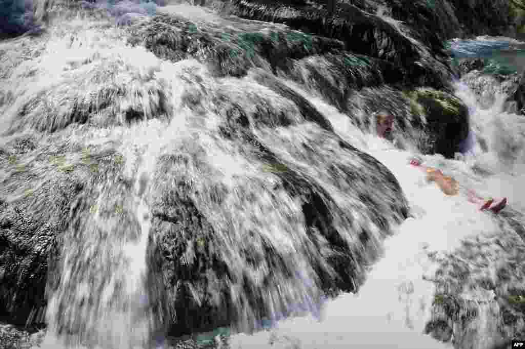 A man enjoys a bath at the hot springs of the famous Thermopylae ( 'the hot gates') in central Greece, Mar. 19, 2014.