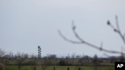 FILE - Greek Army soldiers patrol near the Greek-Turkish border in the village of Kastanies, Evros region, March 10, 2020. 