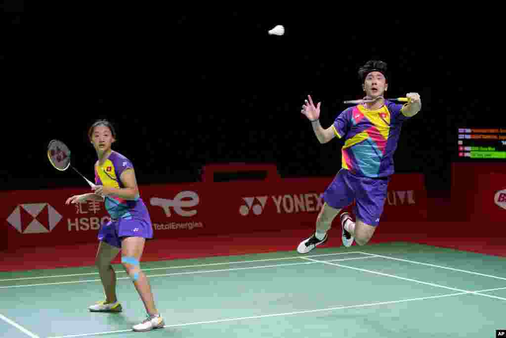 Hong Kong's Tang Chun Man, right, and Tse Ying Suet compete against Thailand's Dechapol Puavaranukroh and Sapsiree Taerattanachai during their mixed doubles badminton group stage match at the BWF World Tour Finals in Nusa Dua, Bali, Indonesia.