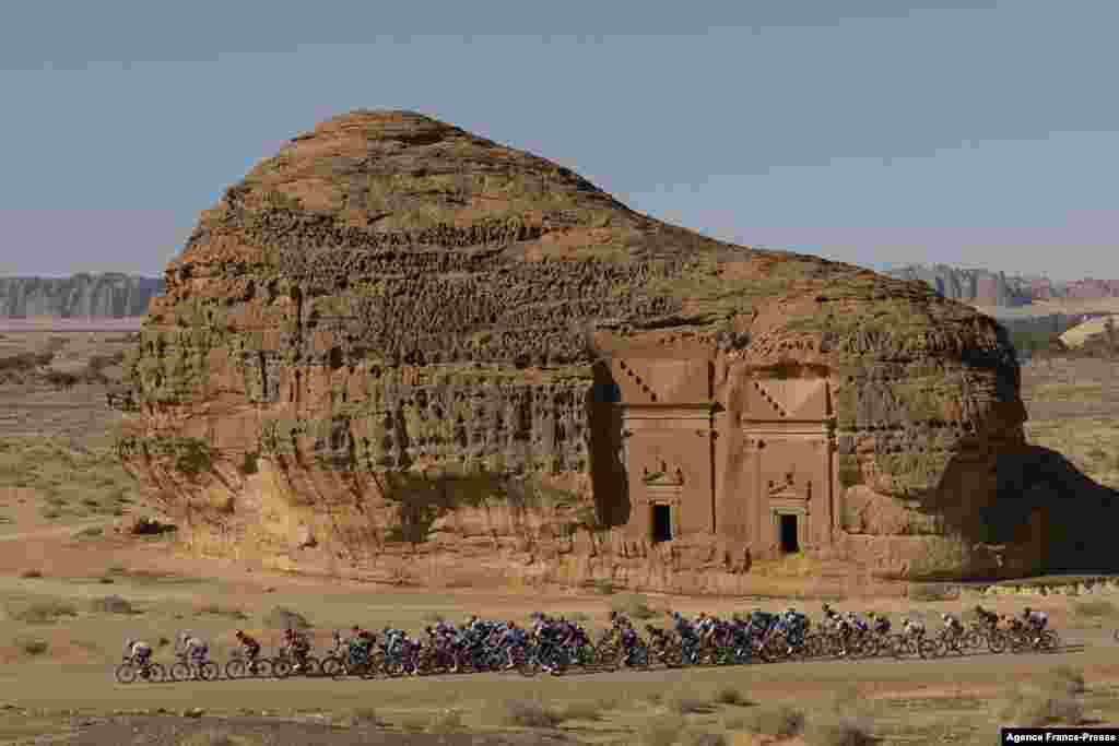 The peloton passes by ancient Nabataean carved tombs as it crosses the archaeological site of al-Hijr (Hegra), during the first stage of the Saudi Tour from Winter Park near Saudi Arabia's northwestern city of al-Ula.