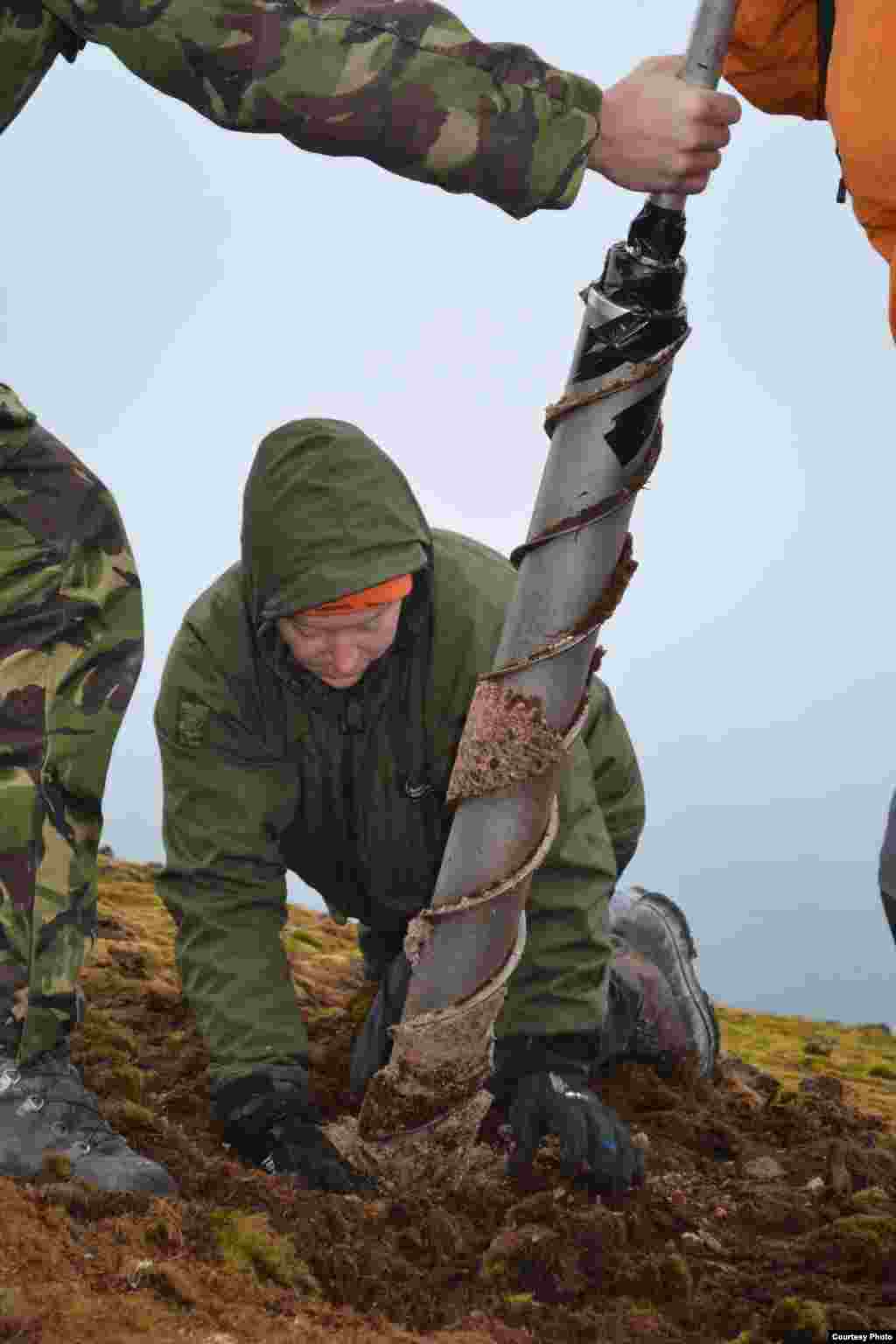 Core head being carefully removed from a moss bank on Elephant Island, South Shetland Islands. (Dan Charman/Matt Amesbury)