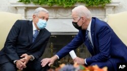 FILE - President Joe Biden (right) meets with Mexican President Andrés Manuel López Obrador in the Oval Office of the White House in Washington, Nov. 18, 2021. The Mexican president will visit the White House this week.