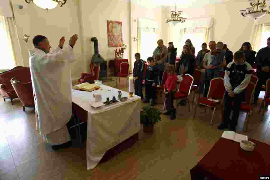 Priest Cezary Korzec conducts a Holy Mass in a chapel in his house in the village of Rosow, Germany, located near the Polish border, April 7, 2013.