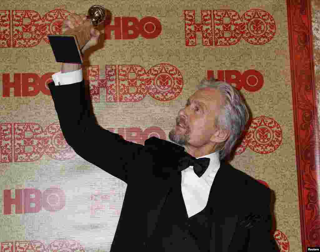 Michael Douglas holds the Golden Globe Award he won as Best Actor, Miniseries or Movie, for his role in HBO's "Behind the Candelabra" at the HBO after party, after the Golden Globe Awards, Jan. 12, 2014.