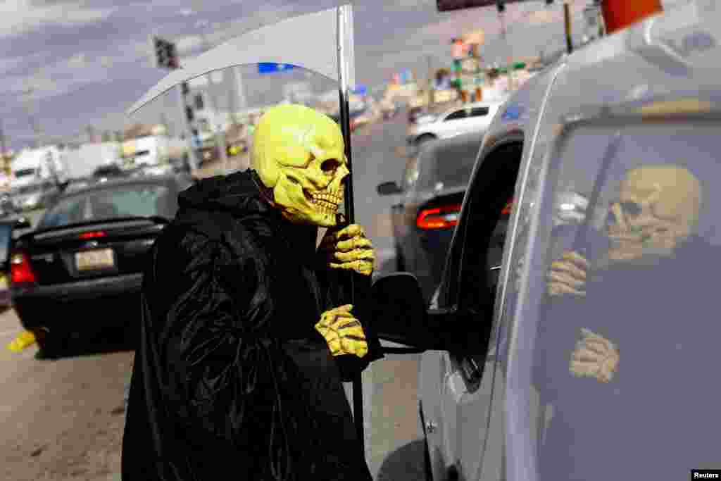 A Civil Protection employee participates in the campaign "Beware of Monoxide, the Silent Killer", which seeks to prevent deaths from poisoning with carbon monoxide through the use of heaters to mitigate low temperatures, in Ciudad Juarez, Mexico, Feb. 2, 2022.