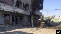 FILE - An Iraqi soldier inspects one of the damaged buildings after clashes between Iraqi security forces and members of the Islamic state in the city of Kirkuk, 180 miles (290 kilometers) north of Baghdad, Iraq, Oct, 22, 2016. 