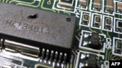 FILE - A key property of today’s computer chips is the distance electrons must travel from one transistor to the next. Thinner transistors means speedier travel for those electrons. 