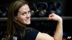 Melissa Breaux Bankston, a CrossFit athletic trainer at CrossFit Algiers in New Orleans, poses for a portrait at the gym Monday, Dec. 23, 2019. She participates in an intermittent fasting diet. (AP Photo/Gerald Herbert)