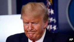 President Donald Trump pauses during a briefing about the coronavirus in the James Brady Press Briefing Room of the White House, March 31, 2020, in Washington. 