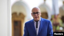FILE - Venezuela's Communications and Information Minister Jorge Rodriguez speaks during a broadcast at the Miraflores Palace in Caracas, March 25, 2019.