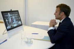 French President Emmanuel Macron attends a donor teleconference with other world leaders concerning the situation in Lebanon following the Beirut blast, in Fort de Bregancon in Bormes-les-Mimosas, France Aug. 9, 2020.