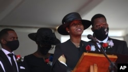 La ex primera dama de Haití, Martine Moïse, habla durante el funeral de su esposo asesinado, el ex presidente Jovenel Moïse, acompañada de sus hijos en Cabo Haitiani, Haití, el viernes 23 de julio de 2021.