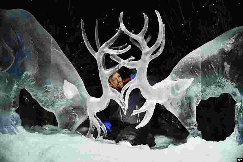 Ice sculptor Darren Jackson puts the finishing touches on an ice sculpture of two stags, which will make up part of a forthcoming exhibition, "The Ice Adventure: A Journey Through Frozen Scotland," in Edinburgh, Scotland, Nov. 14, 2017.