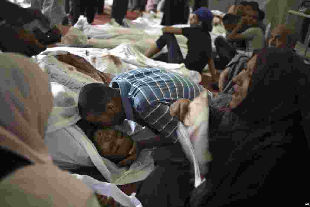 Egyptians mourn over the bodies of their relatives in the El-Iman mosque at Nasr City, Cairo, Augusts 15, 2013.
