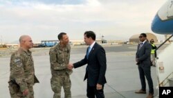 U.S. Defense Secretary Mark Esper, center, is greeted by U.S. military personnel upon arriving in Kabul, Afghanistan, Sunday, Oct. 20, 2019.